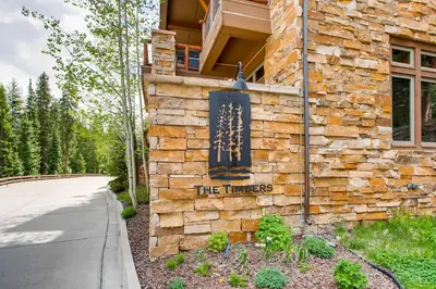 a stone building with a sign on the side of it at Timbers 3060 in Keystone