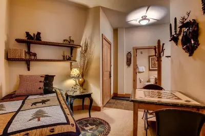 a bedroom with a bed and a desk and a table at Timbers 3060 in Keystone