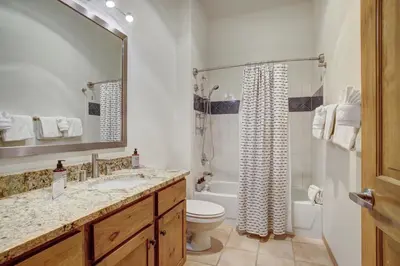 a bathroom with a sink and a toilet and a tub at Black Bear 8079 in Keystone