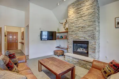 a living room with a large brick fireplace at Black Bear 8079 in Keystone