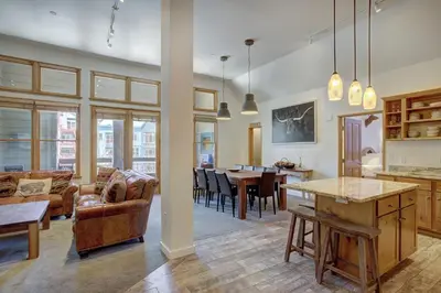 a kitchen and living room with a table and chairs at Black Bear 8079 in Keystone