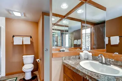 a bathroom with a sink and a toilet and a mirror at Argentine 1525 in Keystone