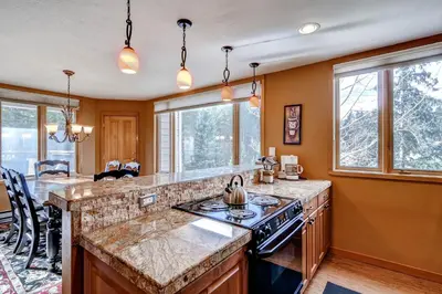 a kitchen with an island with a stove top oven at Argentine 1525 in Keystone