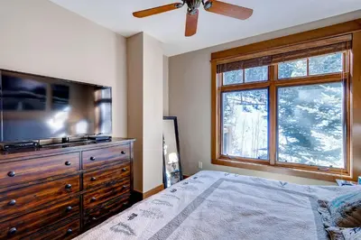 a bedroom with a television and a dresser with a bed at Lone Eagle 3008 in Keystone