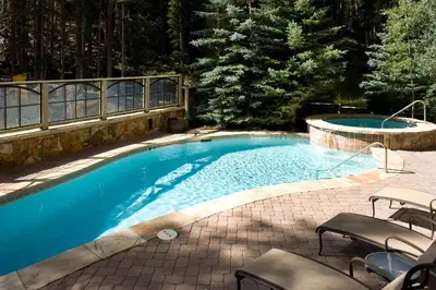 a swimming pool with chairs in a yard at Lone Eagle 3008 in Keystone