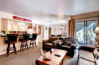 a living room filled with furniture and a kitchen at Flying Dutchman 1124 in Keystone