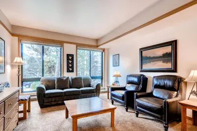 a living room with couches and chairs and a table at Slopeside 2741 in Keystone