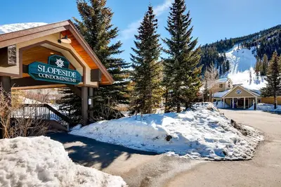 a sign for a ski lodge in the snow at Slopeside 2741 in Keystone