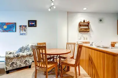 a kitchen and dining room with a table and chairs at Red Hawk Lodge 2207 in Keystone