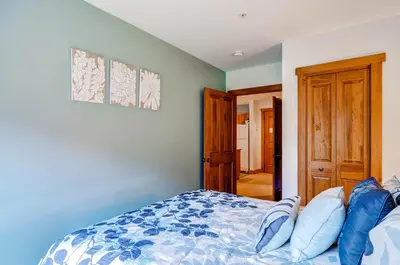 a bedroom with a bed with blue and white sheets at Red Hawk Lodge 2207 in Keystone