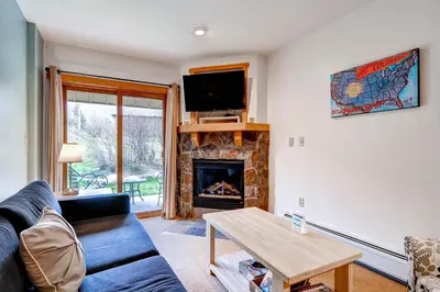 a living room with a couch and a fireplace at Red Hawk Lodge 2207 in Keystone