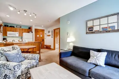 a living room with a couch and a table at Red Hawk Lodge 2207 in Keystone