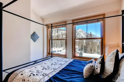 a bedroom with a bed and a large window at Silver Mill 8308 in Keystone