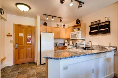 a kitchen with a counter top and a refrigerator at Silver Mill 8308 in Keystone