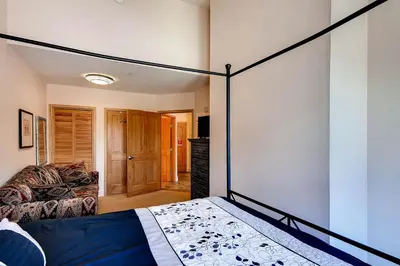 a bedroom with a canopy bed and a couch at Silver Mill 8308 in Keystone
