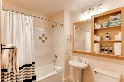 a bathroom with a sink and a tub and a toilet at Silver Mill 8308 in Keystone