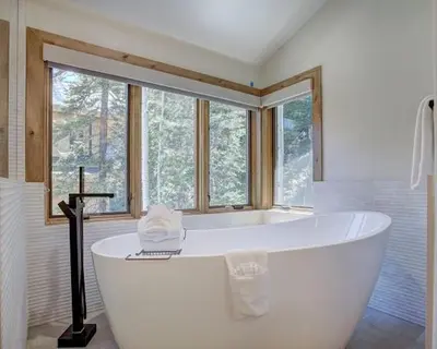 a large white bath tub in a bathroom with a window at Settlers Creek 6466 in Keystone