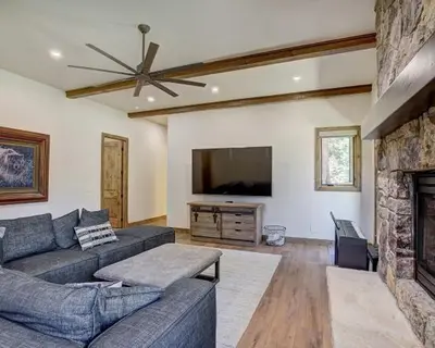 a living room with a couch and a flat screen tv at Settlers Creek 6466 in Keystone