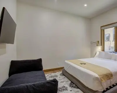 a bedroom with a large bed and a couch at Settlers Creek 6466 in Keystone