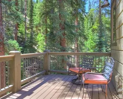 a porch with two chairs and a table on it at Settlers Creek 6466 in Keystone