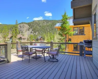 a patio with a table and chairs on a deck at Settlers Creek 6466 in Keystone