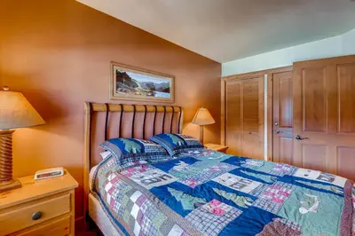 a bedroom with a bed with a quilt on it at Expedition Station 8613 in Keystone