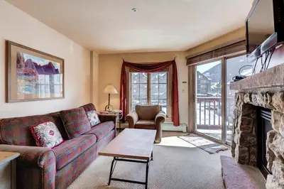 a living room with a couch and a fireplace at Expedition Station 8613 in Keystone