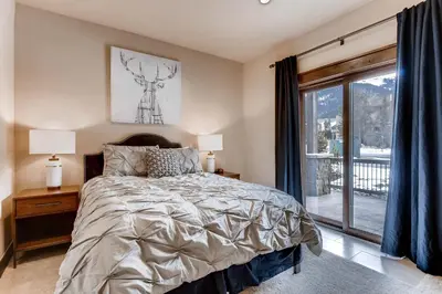 a bedroom with a bed and a window at River Run Townhome RR37 in Keystone