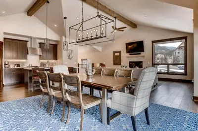 a dining room and kitchen with a table and chairs at River Run Townhome RR37 in Keystone