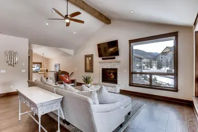 a living room with a couch and a fireplace at River Run Townhome RR37 in Keystone
