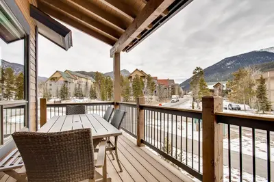 a wooden deck with a table and chairs on a balcony at River Run Townhome RR37 in Keystone