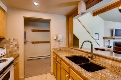 a kitchen with a sink and a stove at Willows 1716 in Keystone