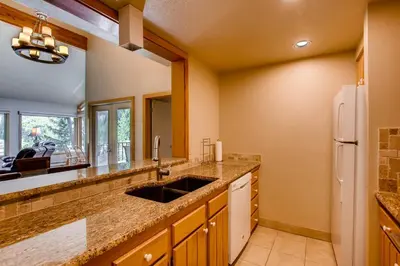 a kitchen with a sink and a refrigerator at Willows 1716 in Keystone