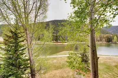 a view of a lake between two trees at Willows 1716 in Keystone