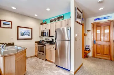 a kitchen with a stainless steel refrigerator and a sink at Buffalo Lodge 8385 in Keystone
