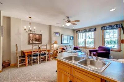 a kitchen and living room with a sink and a table at Buffalo Lodge 8385 in Keystone