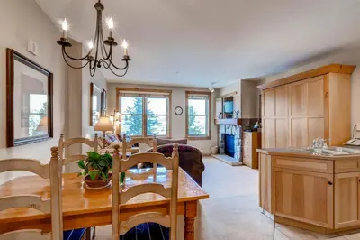 a kitchen and dining room with a wooden table and chairs at Buffalo Lodge 8325 in Keystone