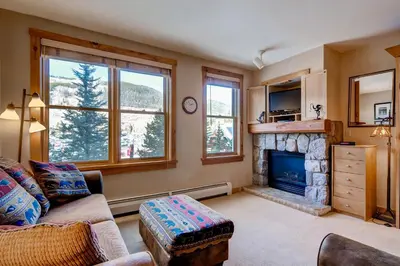 a living room with a couch and a fireplace at Buffalo Lodge 8325 in Keystone