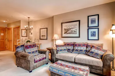 a living room with a couch and a chair at Buffalo Lodge 8325 in Keystone