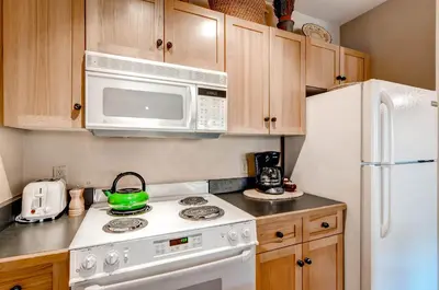 a kitchen with a white stove and a microwave at Buffalo Lodge 8325 in Keystone
