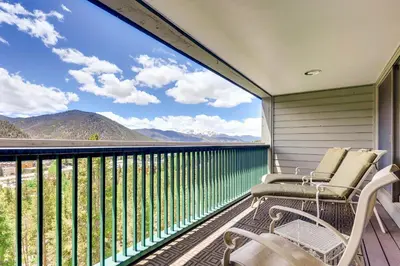 a balcony with two chairs and a view of mountains at Sts, Johns 2541 in Keystone