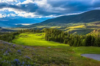 a view of a golf course with mountains in the background at Lone Eagle 3031 in Keystone