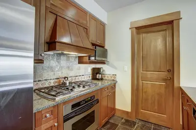 a kitchen with wooden cabinets and a stove top oven at Lone Eagle 3031 in Keystone
