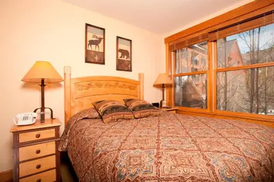 a bedroom with a bed and a large window at Springs 8848 in Keystone