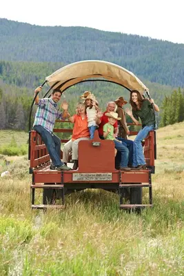 a group of people riding in the back of a truck at Springs 8848 in Keystone