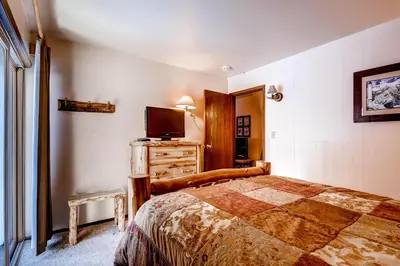 a bedroom with a bed and a tv on a dresser at Flying Dutchman 1210 in Keystone