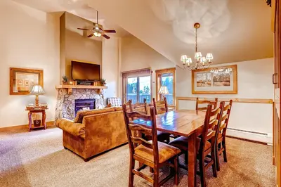 a dining room with a table and a couch at Red Hawk 2291 in Keystone