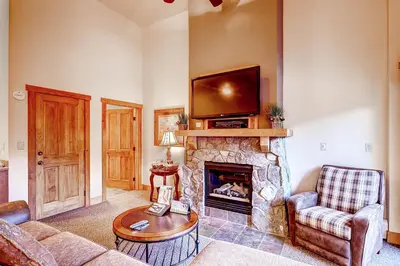 a living room with a fireplace with a tv on top at Red Hawk 2291 in Keystone