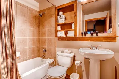 a bathroom with a sink and a toilet and a tub at Red Hawk 2291 in Keystone