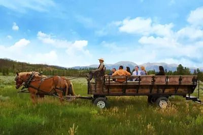 a group of people riding in a horse drawn carriage at Red Hawk 2291 in Keystone